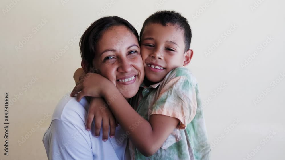 Happy Latin mother and son having fun hugging each other. Family relationship and love concept Happy Latin mother and son having fun hugging each other. Family relationship and love concept