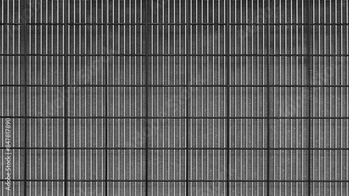 Wallpaper Mural A black and white photo of a wall with a grid pattern. The photo has a moody and somewhat eerie feel to it Torontodigital.ca