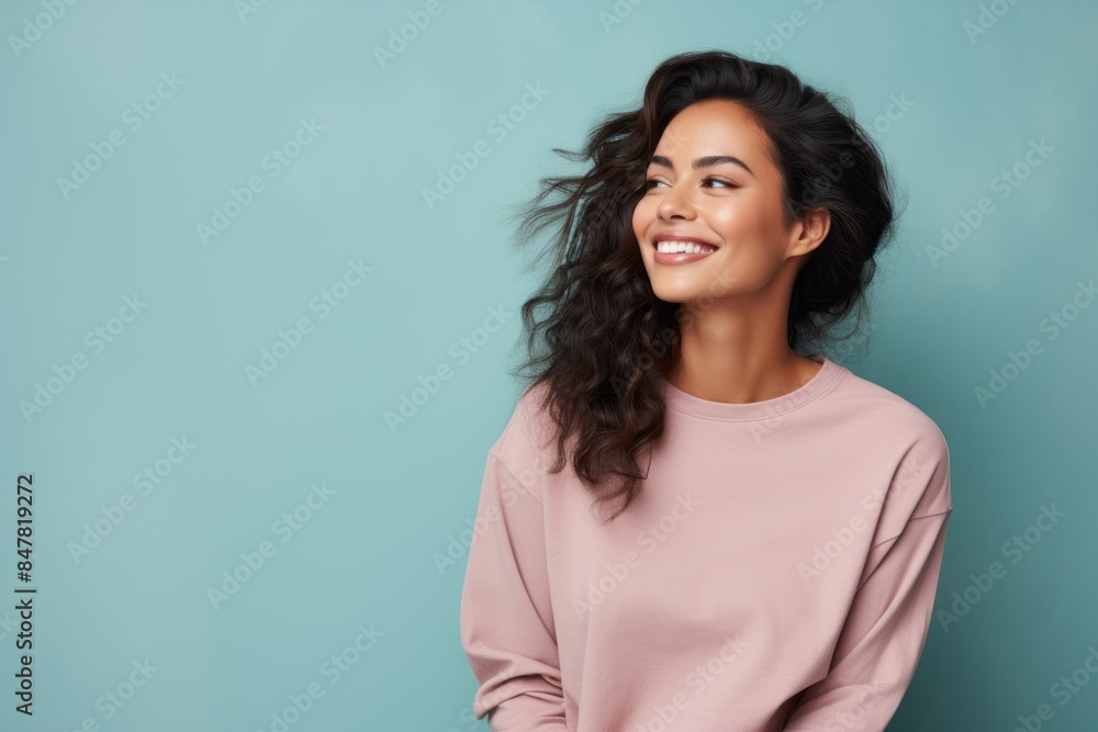 Portrait of a blissful indian woman in her 30s dressed in a comfy fleece pullover isolated on pastel or soft colors background Portrait of a blissful indian woman in her 30s dressed in a comfy fleece pullover isolated on pastel or soft colors background