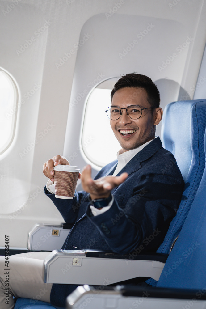 Successful business man, Airplane, travel, enjoying comfortable flight while sitting in the airplane cabin. Successful business man, Airplane, travel, enjoying comfortable flight while sitting in the airplane cabin.