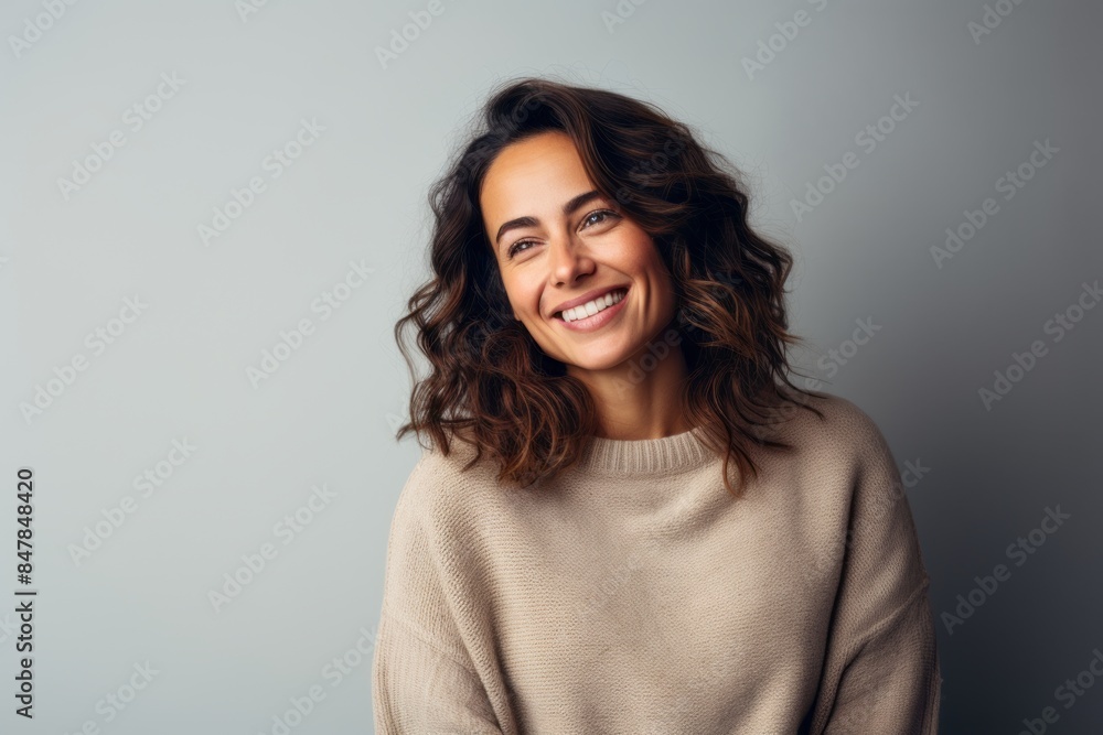 Portrait of a cheerful woman in her 30s dressed in a warm wool sweater isolated on minimalist or empty room background Portrait of a cheerful woman in her 30s dressed in a warm wool sweater isolated on minimalist or empty room background