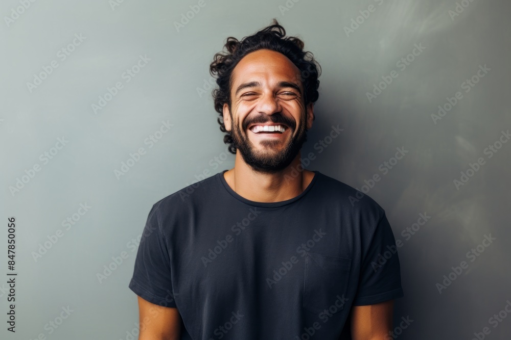 Portrait of a happy man in his 30s donning a trendy cropped top on minimalist or empty room background Portrait of a happy man in his 30s donning a trendy cropped top on minimalist or empty room background