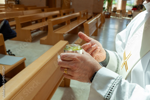 Foto Priest with a stole and a silver jar of holy chrism oil for sacraments