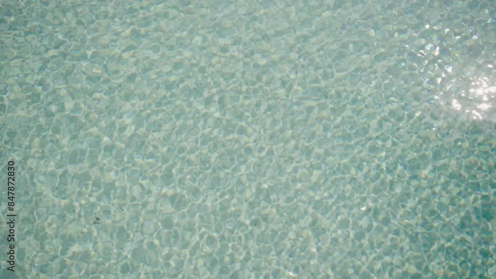 Blue water in the swimming pool with light reflections. swimming pool ripples and wave, Refraction of sunlight top view texture sea side, sun shine water background. Water Blue water in the swimming pool with light reflections. swimming pool ripples and wave, Refraction of sunlight top view texture sea side, sun shine water background. Water