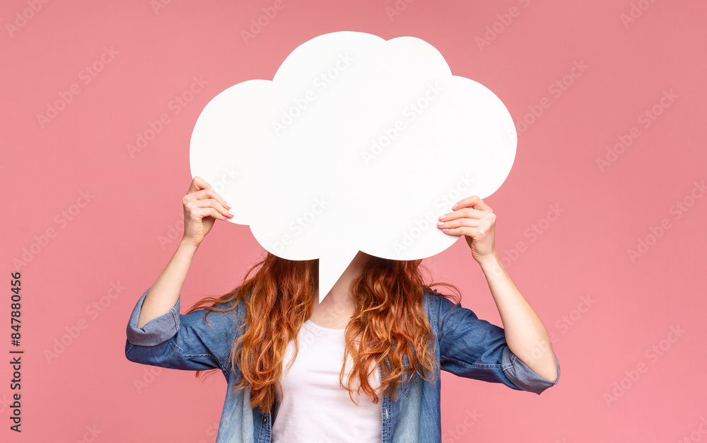 A woman stands with outstretched arms, holding a large white cloud over hear face, expressing her opinion on pink background