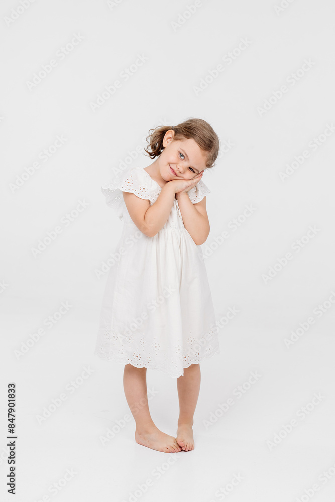 Little sensual girl on a light background. The concept of style, fashion, sensuality and carefree childhood. Little sensual girl on a light background. The concept of style, fashion, sensuality and carefree childhood.