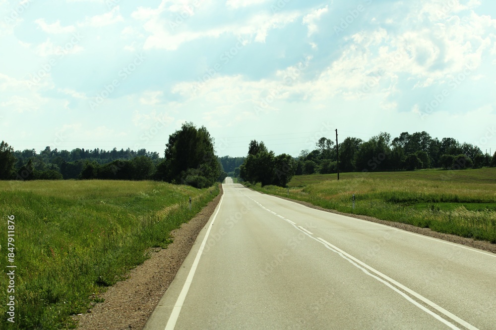 panoramic view with an asphalt road stretching into the distance and a blue sky in the background panoramic view with an asphalt road stretching into the distance and a blue sky in the background