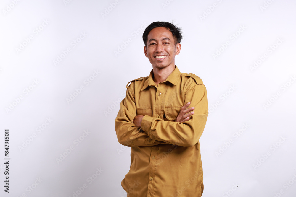 Indonesian government employees standing while smiling and looking at the camera. Isolated on white Indonesian government employees standing while smiling and looking at the camera. Isolated on white