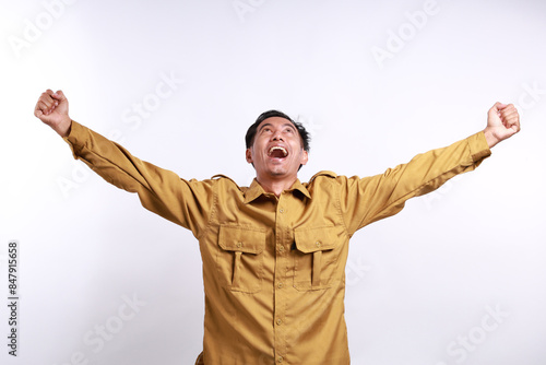 Successful Indonesian government employees standing with clenched hand. Isolated on white background photo