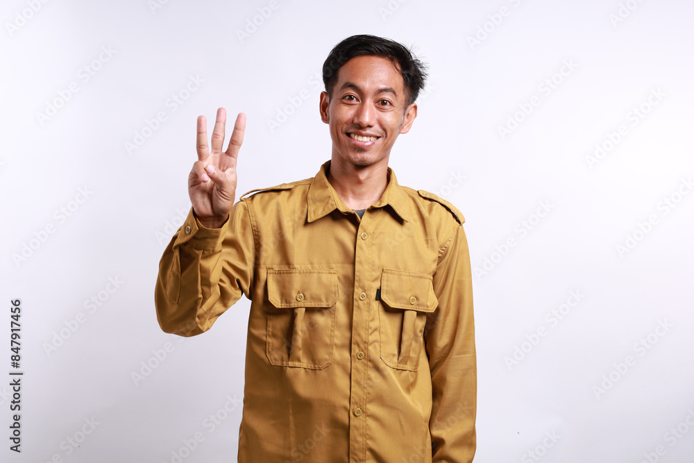 Happy Indonesian government employees standing while showing three fingers. Isolated on white Happy Indonesian government employees standing while showing three fingers. Isolated on white