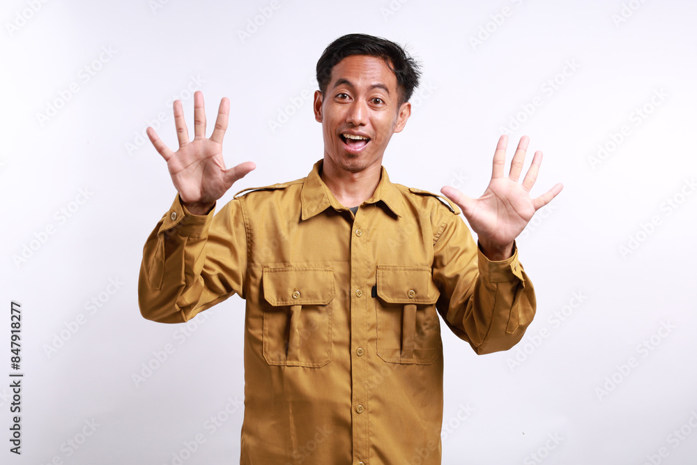 Happy Indonesian government employees standing while showing ten fingers. Isolated on white Happy Indonesian government employees standing while showing ten fingers. Isolated on white