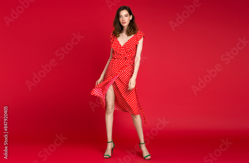 stylish woman in summer fashion trend dress on red background © mary_markevich