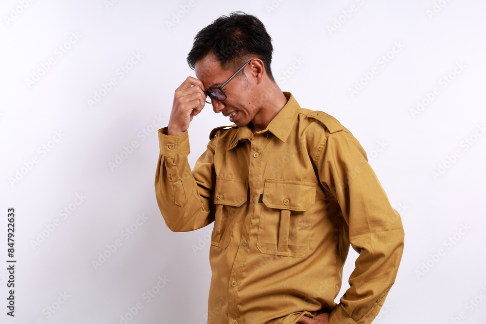 Indonesian civil servant having headache, hand holding head