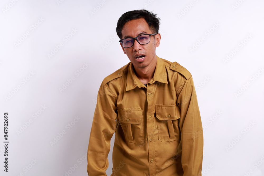 Tired Indonesian government employees while standing. Isolated on white background Tired Indonesian government employees while standing. Isolated on white background