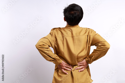 Back view of civil servant man suffering from back pain. Isolated on white