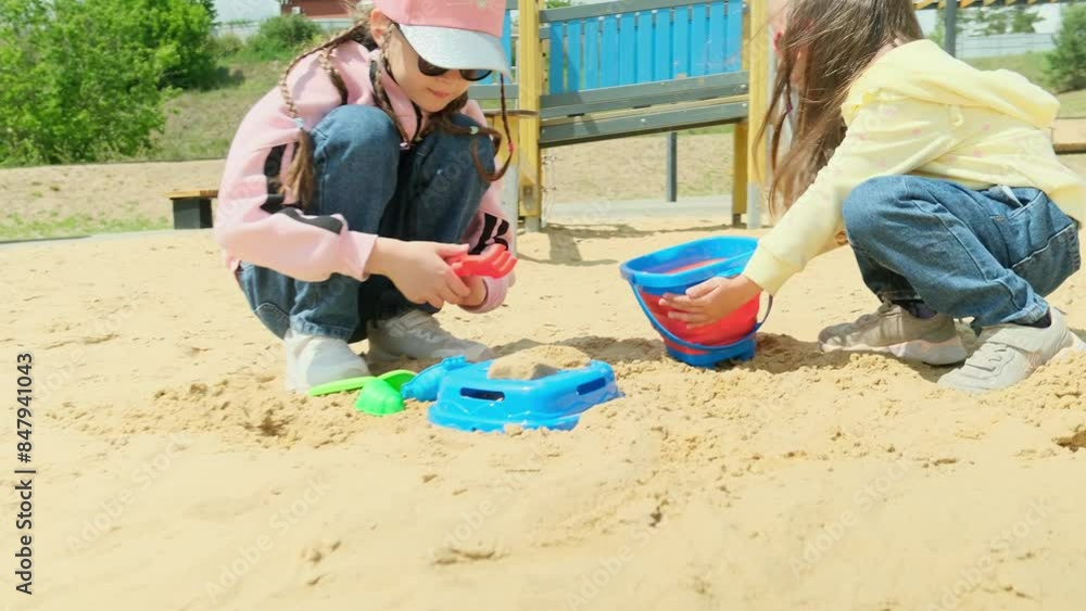 Adorable 4 years old little girl is playing the sand with her friend sisters with fully happiness moment, concept of outdoor freeplay for kid development. Adorable 4 years old little girl is playing the sand with her friend sisters with fully happiness moment, concept of outdoor freeplay for kid development.