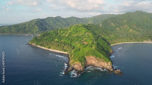 Senggigi, Lombok: Cinematic aerial drone footage of the dramatic coast of Lombok island near Senggigi in Indonesia. Shot with a rotation motion.  photo