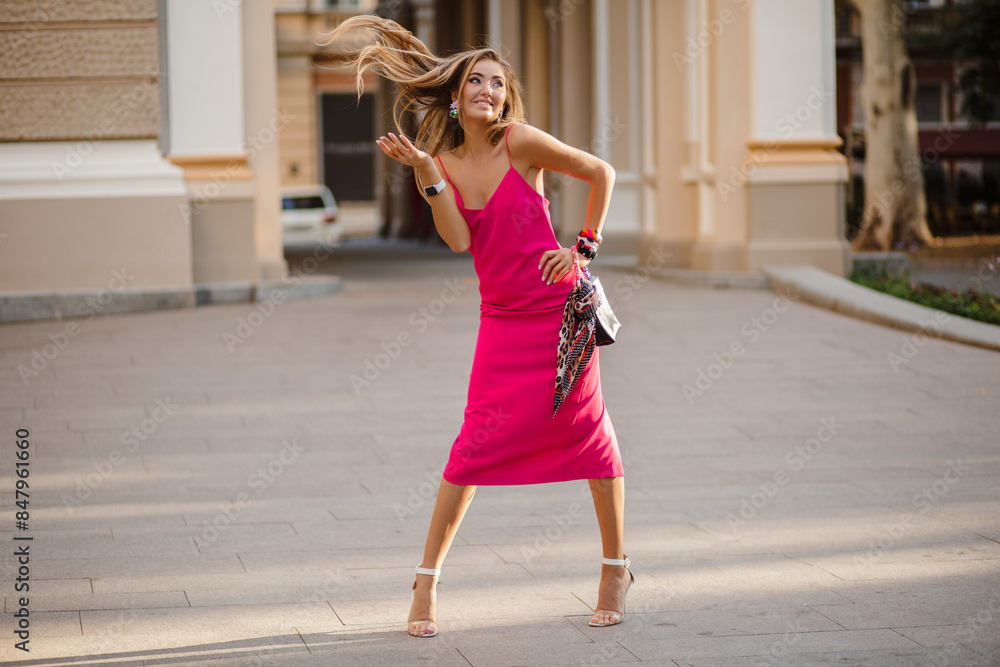elegant attractive woman wearing pink sexy summer dress walking in street elegant attractive woman wearing pink sexy summer dress walking in street