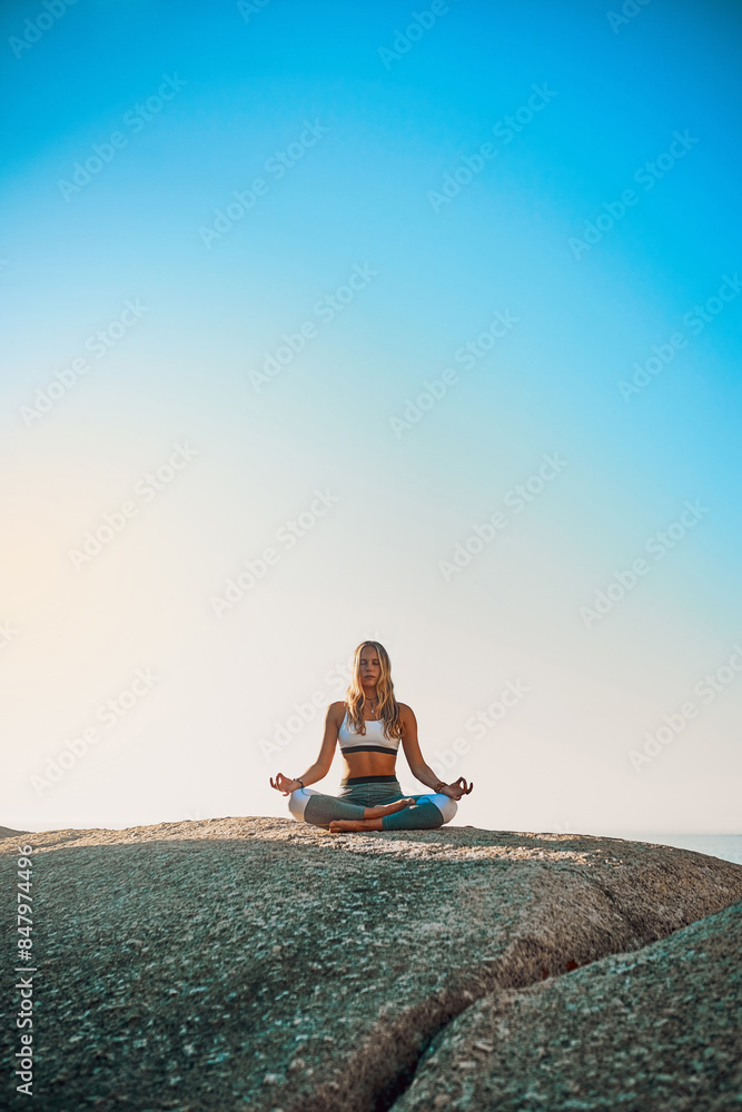 Cliff, meditation and girl with zen for yoga, wellness and spiritual peace in California. Chakra, female yogi and outdoor lotus pose for calm, relaxing and mental health by rock outdoors in beach Cliff, meditation and girl with zen for yoga, wellness and spiritual peace in California. Chakra, female yogi and outdoor lotus pose for calm, relaxing and mental health by rock outdoors in beach