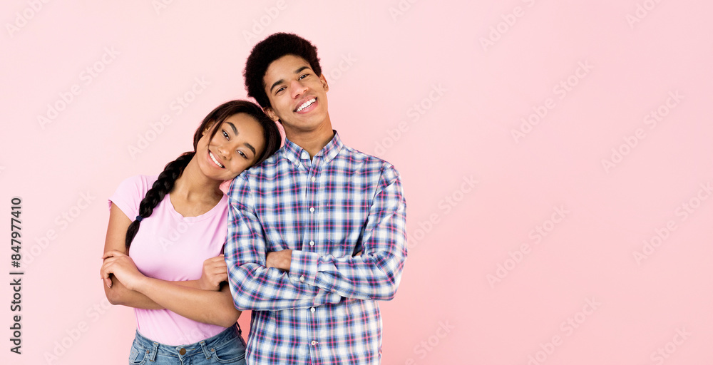 Loving teen girl putting head on male shoulder over pink background, crop Loving teen girl putting head on male shoulder over pink background, crop