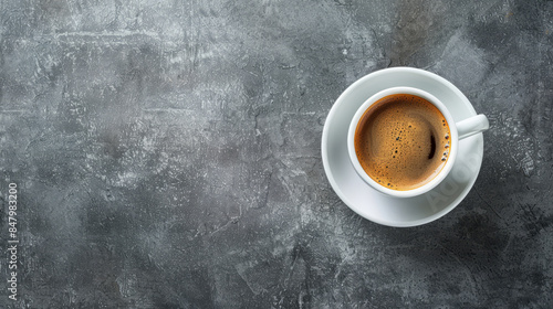 Cup of coffee on grey background top view