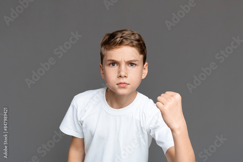 Принти на полотні This image captures a teenager clenching his fist in determination or defiance,