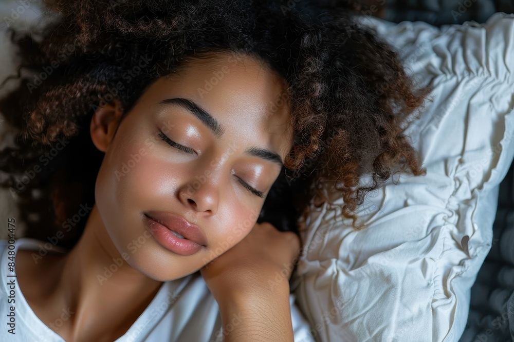 A young woman resting with a serene expression, lying comfortably with closed eyes A young woman resting with a serene expression, lying comfortably with closed eyes
