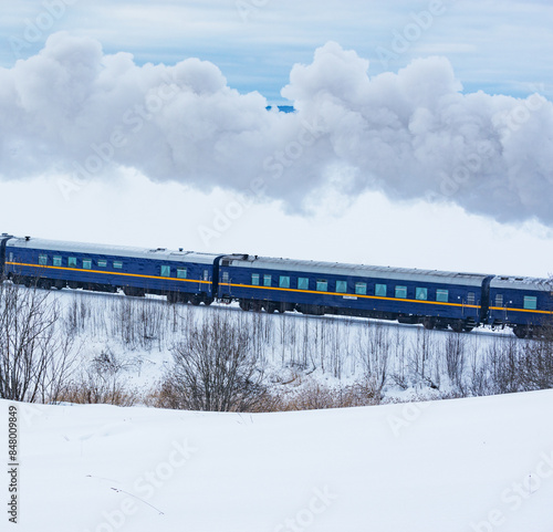 Retro steam train moves at winter.