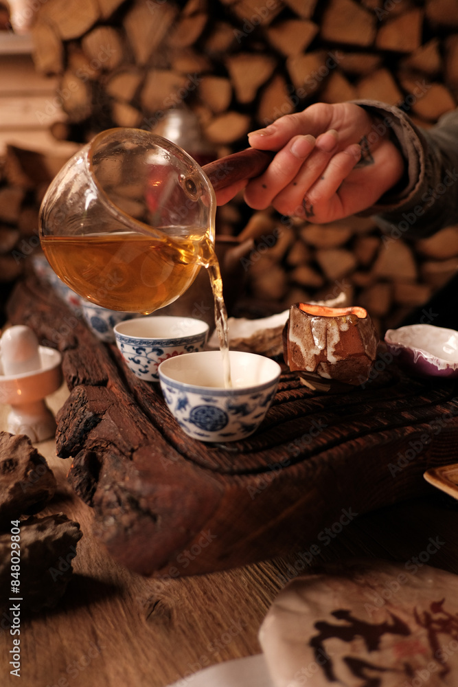 Host pouring tea to a guest on a tea ceremony Host pouring tea to a guest on a tea ceremony