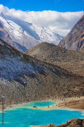 This picture is taken from the North Annapurna Base Camp, Nepal during  November of 2023. The blue frozen lake seen in the picture is called Panchakunda Lake.