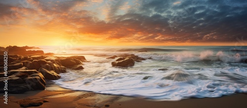 Waves hitting the rocky shore of the beach at sunrise. Creative banner. Copyspace image