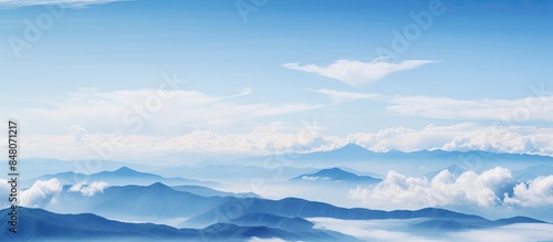 Clouds falling on mountains in blue sky background. Creative banner. Copyspace image