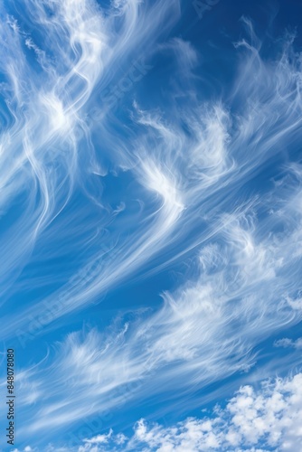 A single-engine plane flying through a clear blue sky with white clouds © Fotograf