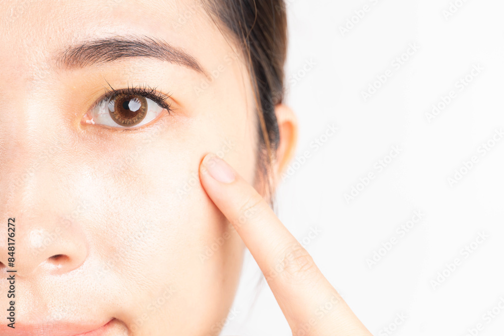Beauty asian woman touching her healthy eyes over white background. Optimal eyes health care concept. Close up. Beauty asian woman touching her healthy eyes over white background. Optimal eyes health care concept. Close up.