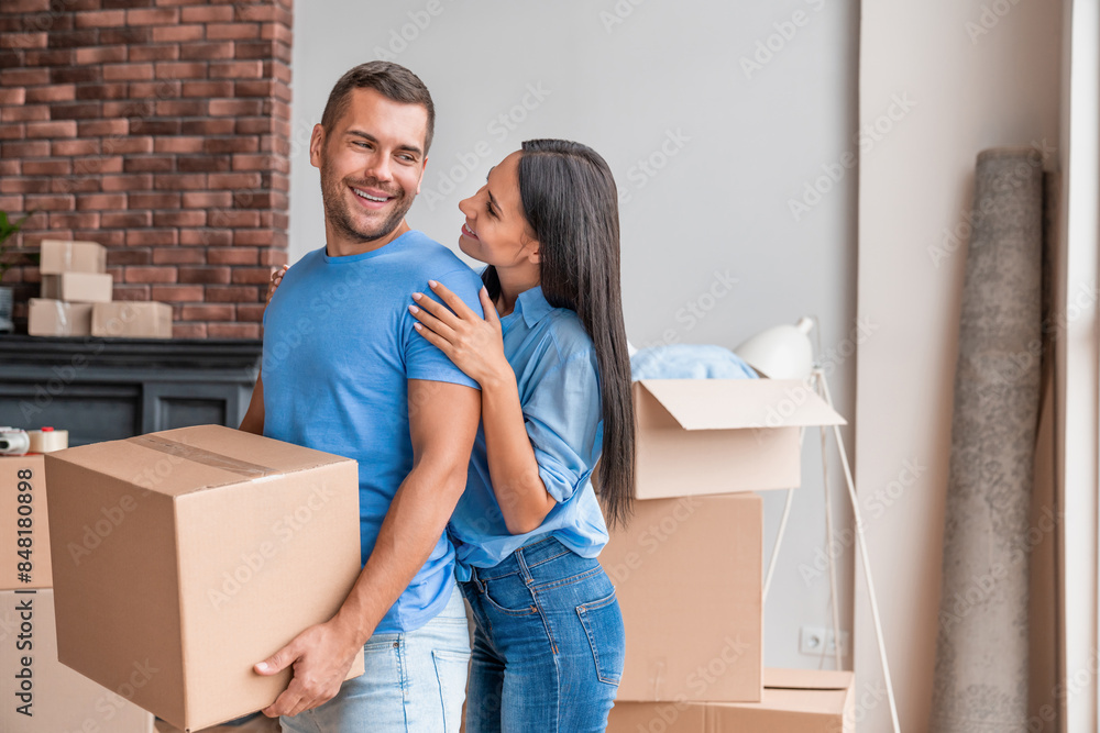 Beautiful young couple hugging in love while moving to new apartment. Family new home moving in: happy and excited wife and husband enter newly purchased apartment. Beautiful young couple hugging in love while moving to new apartment. Family new home moving in: happy and excited wife and husband enter newly purchased apartment.