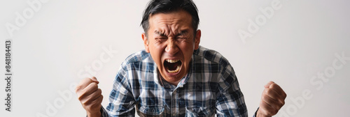 a Japanese man expressing frustration on a studio background photo