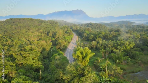 Voo sobre mata atlântica e estrada de Antonina com pico Marumbi ao fundo na região de Morretes no Paraná photo