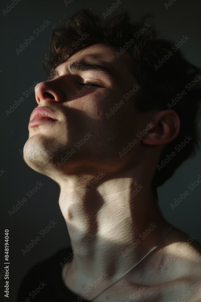 Obraz premium A close-up shot of a person with their eyes shut, possibly in meditation or contemplation