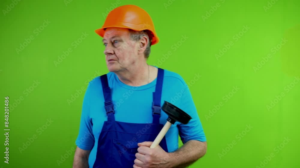Worker with toilet plunger looks around, does not understand cause of breakdown. Worker with toilet plunger looks around, does not understand cause of breakdown.