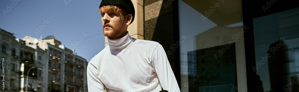 Young red-haired man in white shirt and debonair attire standing in front of a building. Young red-haired man in white shirt and debonair attire standing in front of a building.