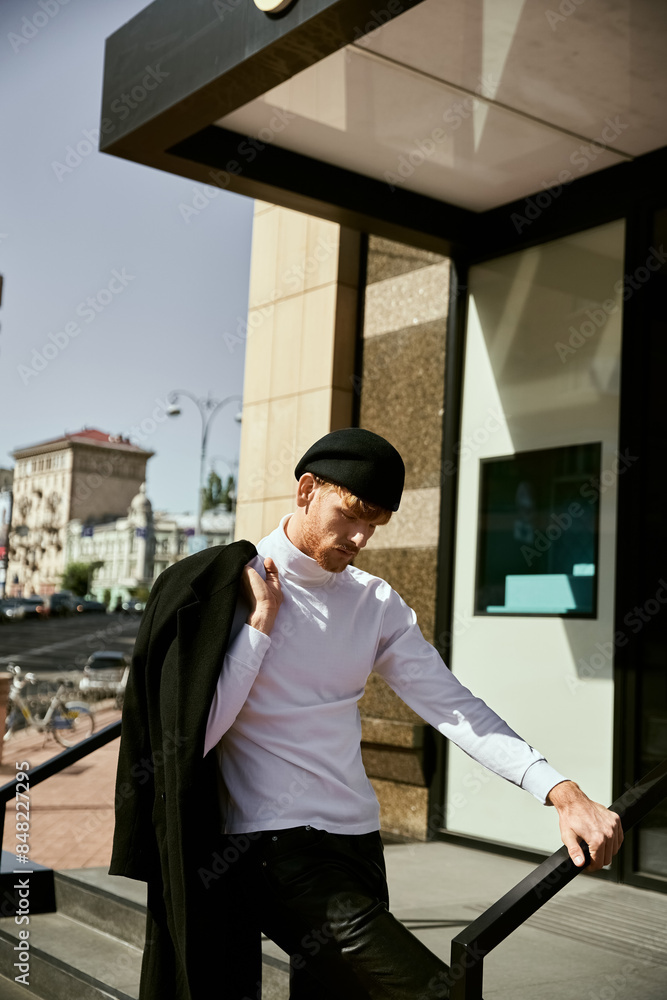 A young red-haired man exudes elegance in a white shirt and black pants while strolling through the city. A young red-haired man exudes elegance in a white shirt and black pants while strolling through the city.