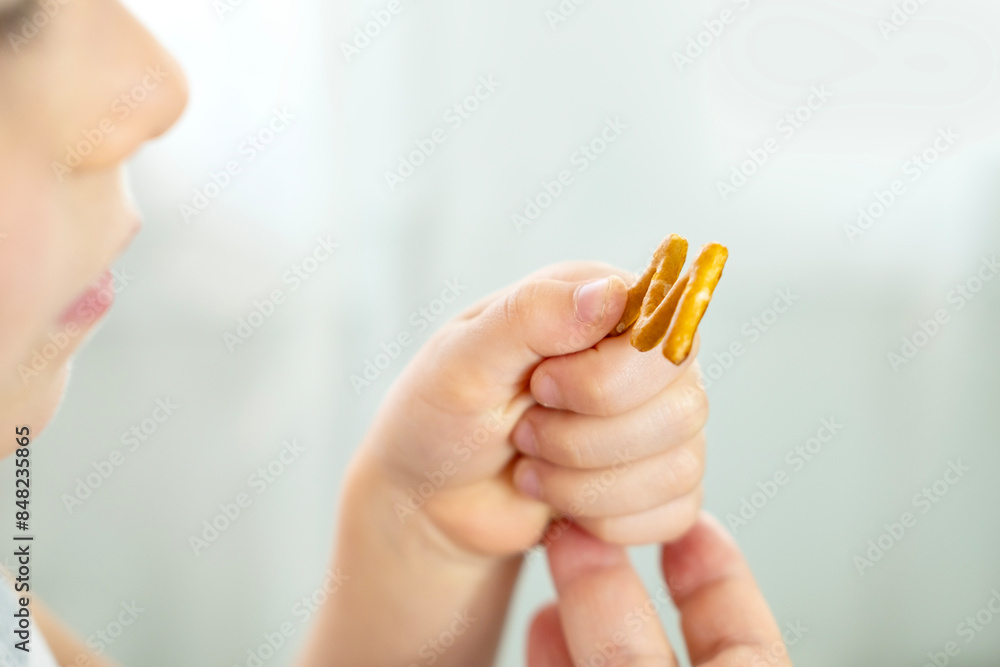 cute cheerful small child, blonde girl 5 years old enjoys crackers in shape letters, learning alphabet fun, happy childhood, Child Nutrition cute cheerful small child, blonde girl 5 years old enjoys crackers in shape letters, learning alphabet fun, happy childhood, Child Nutrition