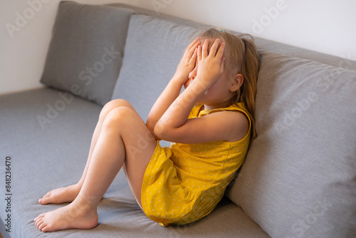 Bild auf Leinwand little child 5 years old, blonde girl cries, covering face, early diagnosis and