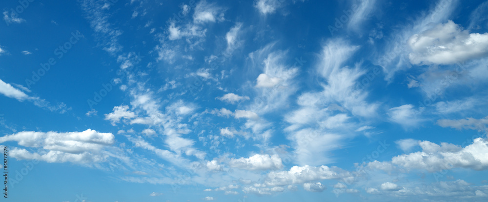 Sun shining through the puffy clouds. Sky view. Beautiful sunny sky. Background with clouds on blue sky. Clouds on blue sky. Sun shining through the puffy clouds. Sky view. Beautiful sunny sky. Background with clouds on blue sky. Clouds on blue sky.