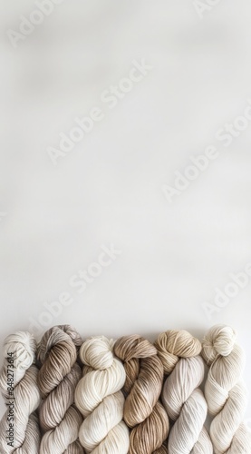 Minimalist Yarn Display: Neatly Arranged Colorful Wool Skeins Against White Background photo