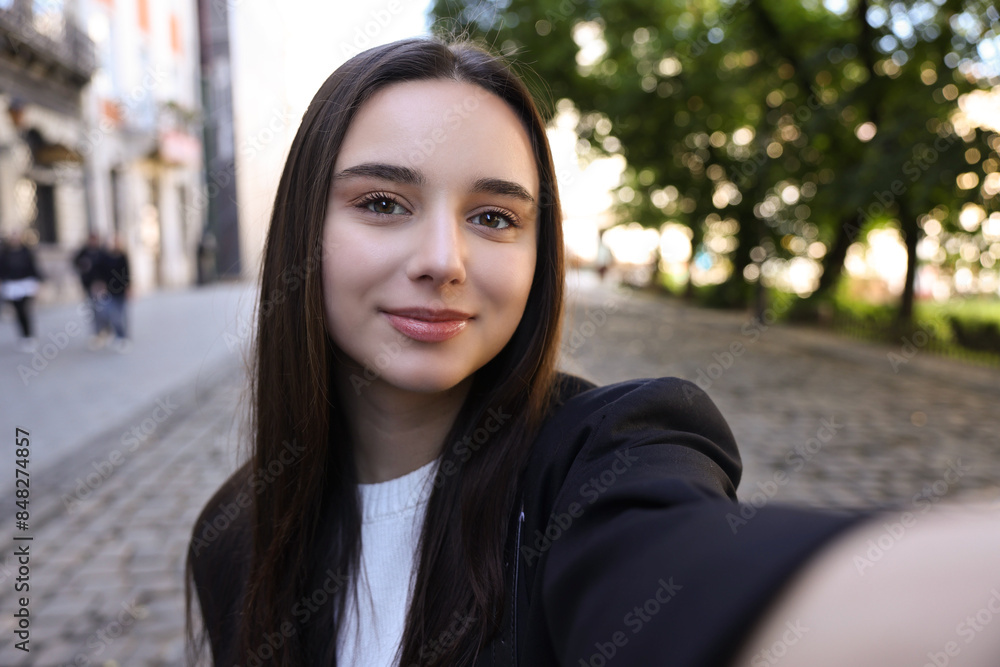 Beautiful young travel blogger takIng selfie outdoors Beautiful young travel blogger takIng selfie outdoors