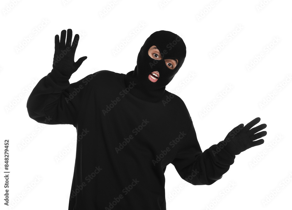 Emotional thief in balaclava raising hands on white background Emotional thief in balaclava raising hands on white background