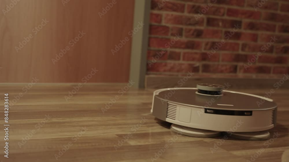 A robot is standing on a wooden floor. The robot is white and has a black head A robot is standing on a wooden floor. The robot is white and has a black head