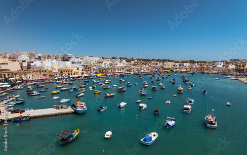 Amazing landscape about the Marsaxlokk city in Mlata island. This city is famous from food market on the shore and colorful fisherboats photo