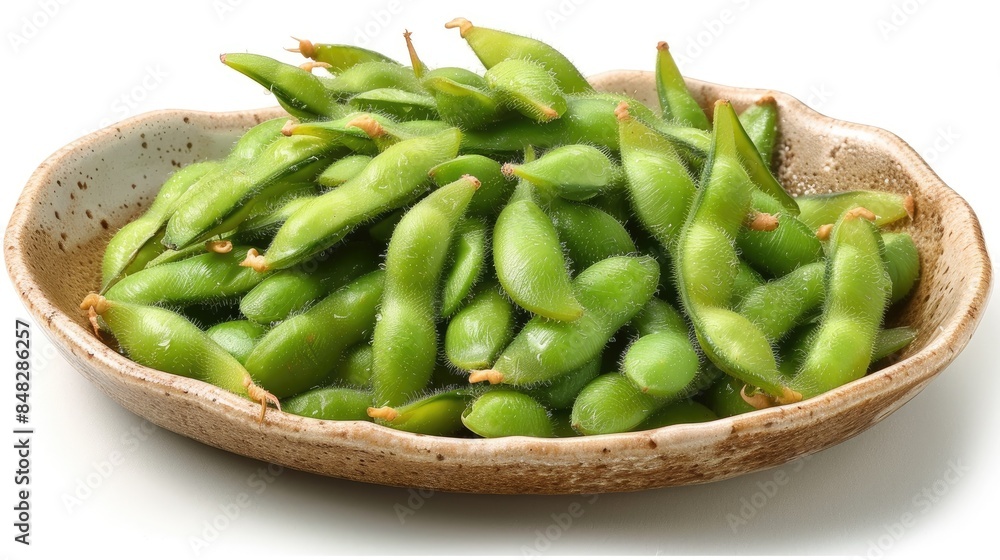 Edamame prepared on a dish against a white backdrop Edamame prepared on a dish against a white backdrop
